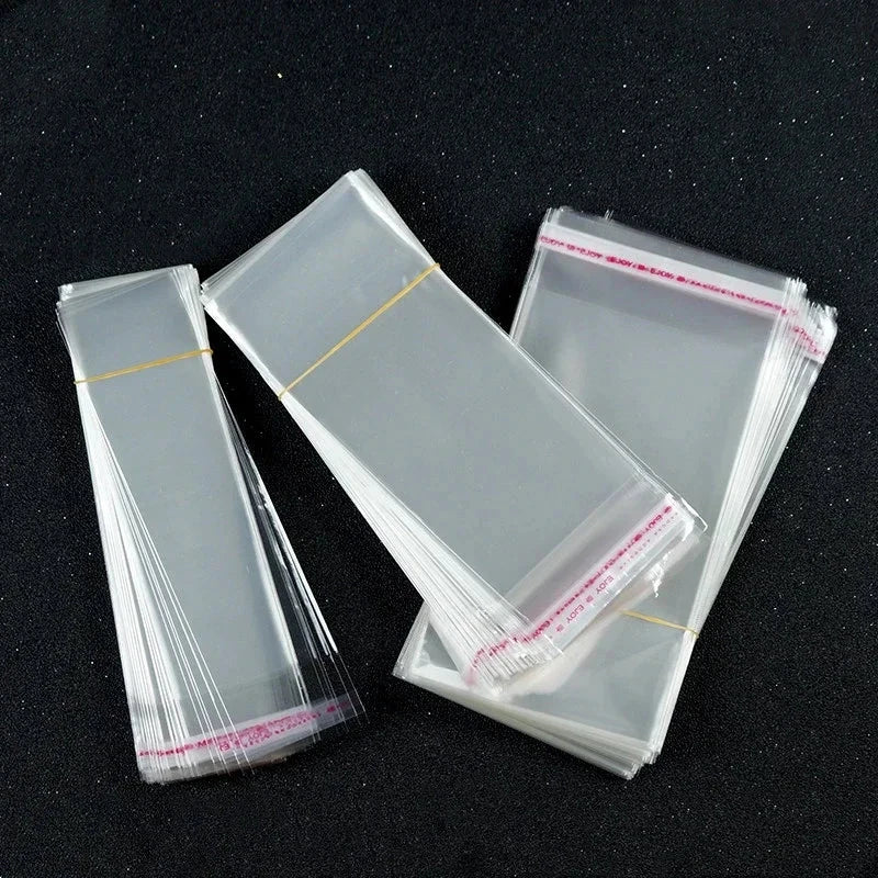 100pcs Opp Self Adhesive Bag Long Transparent Packaging Bags Universal Dust Water Proof Wrapping Material 99 in 1
