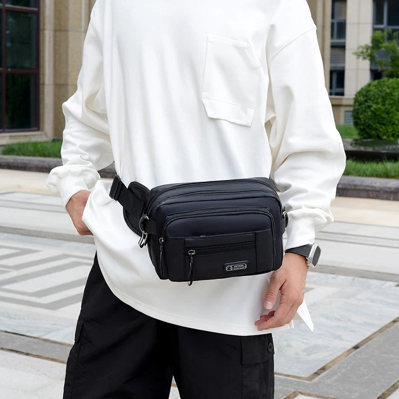 Men’s waist bag worn by a person in a white shirt and black pants, suitable for outdoor sports and running.